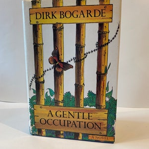 May include: A book cover featuring a white background with a bamboo fence topped with barbed wire. The title "A Gentle Occupation" is displayed on a wooden sign, accompanied by a butterfly on the fence. The author's name, "Dirk Bogarde", is on a sign above the fence. The book is a novel.