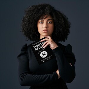 May include: A woman with curly black hair is holding a black book with the title "Twitter Secret Hacks" and a logo of a stylized letter "X".