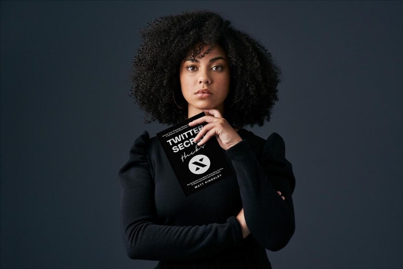 May include: A woman with curly black hair is holding a black book with the title "Twitter Secret Hacks" and a logo of a stylized letter "X".