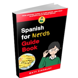 May include: A paperback book titled "Spanish for Nerds Guide Book" with a black cover and red accents. The cover features a cartoon illustration of a person wearing glasses and a map of Spain. The author's name, Matt Kingsley, is at the bottom.