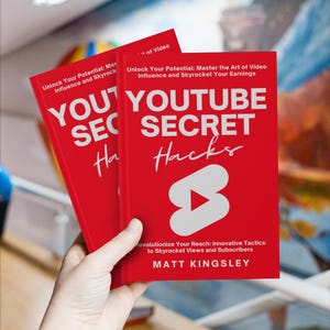 May include: Two red books titled "YouTube Secret Hacks" with a white play button icon on the cover. The book is about unlocking your potential and mastering the art of video influence.