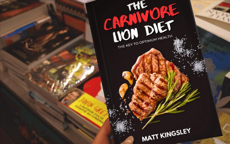 Puede incluir: Un libro negro con el t&iacute;tulo "The Carnivore Lion Diet: The Key to Optimum Health" en letras blancas y rojas. La portada presenta un primer plano de carne a la parrilla con romero y sal.