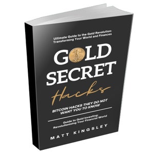 May include: A hardcover book titled "Gold Secret Hacks" with a black cover. The title is in large white letters with "Hacks" in gold script. The book also features the text "Bitcoin Hacks They Do Not Want You to Know" and "Guide to Gold Investing".