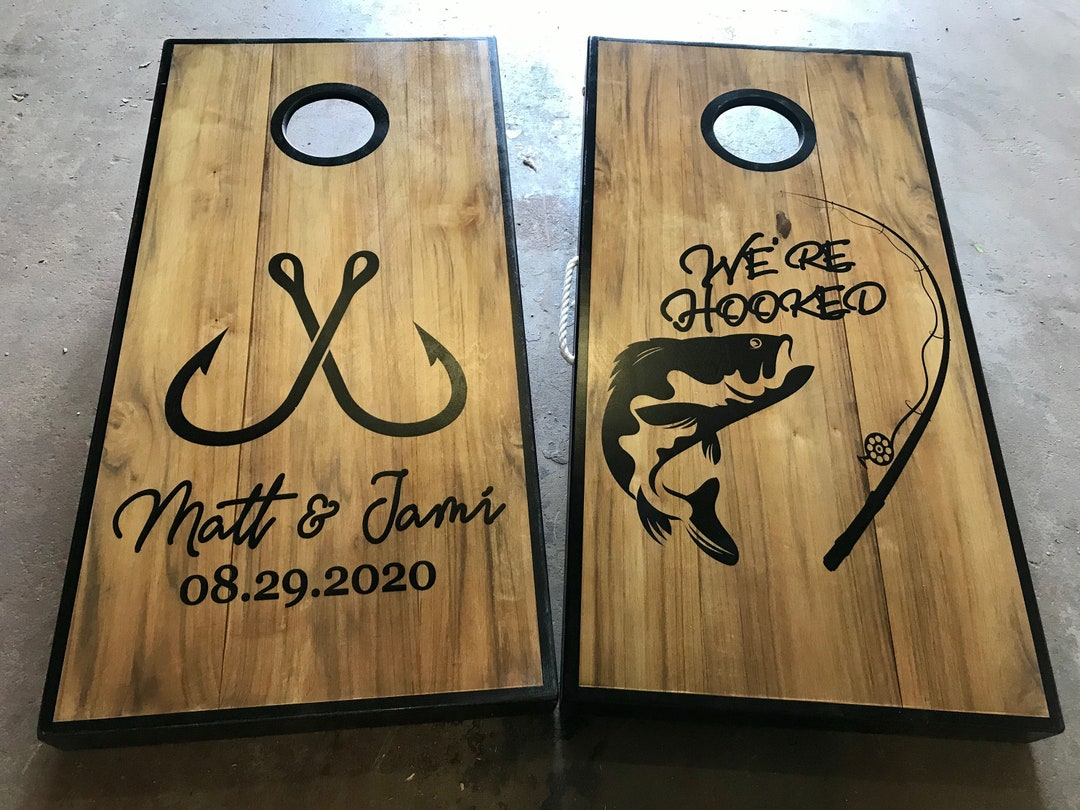 customcorntoss really hooked fish co Custom Fishing Cornhole Boards, Outdoor Wedding, We're Hooked, Adventurous  Couple, Fishing, Fish Hooks, Custom Cornhole Boards Fishing Theme