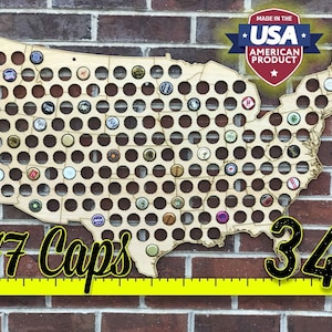 May include: A wooden map of the United States with 177 holes for bottle caps. The map is 34 inches wide and is made in the USA.  The map is mounted on a brick wall.