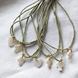 Set of sage green, curry yellow or purple and gold cord bracelets and its mother-of-pearl cross to tie on the wrists of your baptism guests