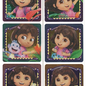 May include: A sheet of six stickers featuring the animated character Dora the Explorer. Each sticker shows Dora with a backpack, wearing a pink shirt, and smiling. The stickers have a decorative border with a jungle theme.
