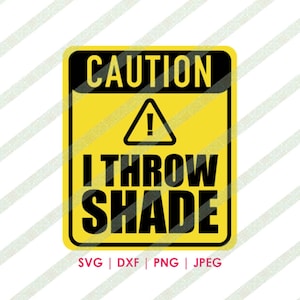 May include: A yellow caution sign with black text and a black exclamation point. The sign reads "CAUTION I THROW SHADE".