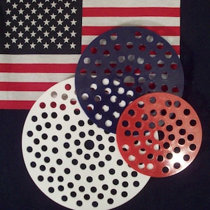 May include: Three round, perforated, plastic discs in red, white, and blue. The discs are stacked on top of each other, with the largest disc on the bottom and the smallest disc on top.