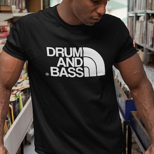 May include: A black t-shirt with a white graphic of a mountain range and the text "DRUM AND BASS".