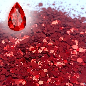 May include: Red glitter with a holographic finish. The glitter is in a loose pile and appears to be made of small, irregular shapes.
