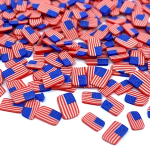 May include: A large quantity of small, rectangular, red, white, and blue American flag-themed embellishments.