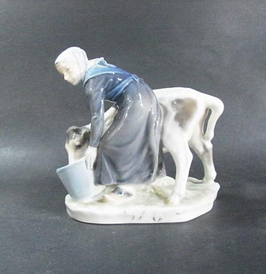 Royal Copenhagen Woman Feeding Cow, Porcelain, #779, Designed by