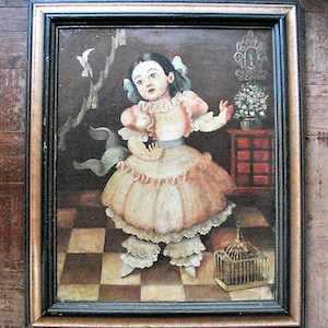 May include: A framed oil painting of a young girl in a pink dress with white lace trim. She is holding a small white bird in her right hand. The painting is set against a backdrop of a checkered floor and a wooden cabinet with a birdcage on top.