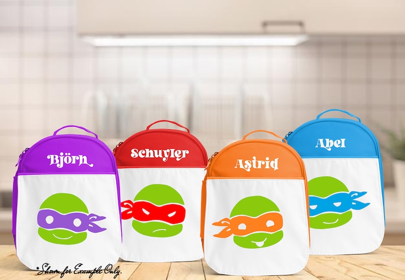 May include: Four colorful lunch bags with white personalized names and Teenage Mutant Ninja Turtles graphics. The bags are purple, red, orange, and blue.