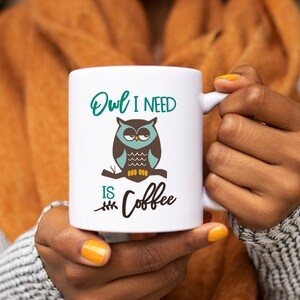 May include: White ceramic mug with a green, brown, and blue owl illustration and the text "Owl I need is coffee".