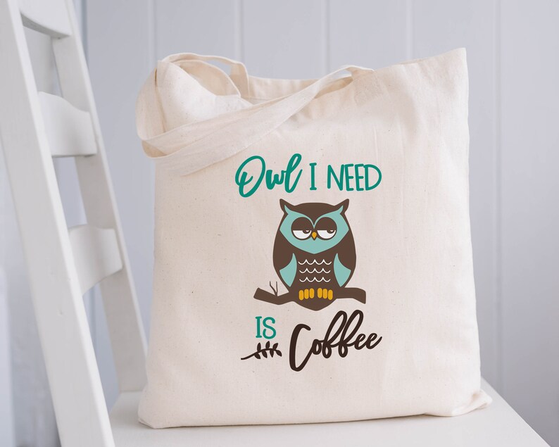 May include: A white canvas tote bag with a green and brown owl graphic and the text "Owl I need is coffee".