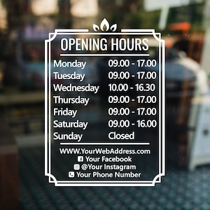 May include: White sign with black text on a glass door, listing opening hours for a business. The sign includes the days of the week and corresponding hours of operation, along with the business's website, Facebook, Instagram, and phone number.