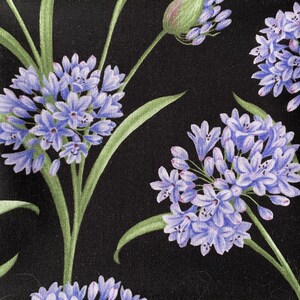 May include: A black fabric featuring a repeating pattern of light purple agapanthus flower clusters with green stems and leaves. The floral design displays multiple spherical blooms in various stages of opening against a solid black background.