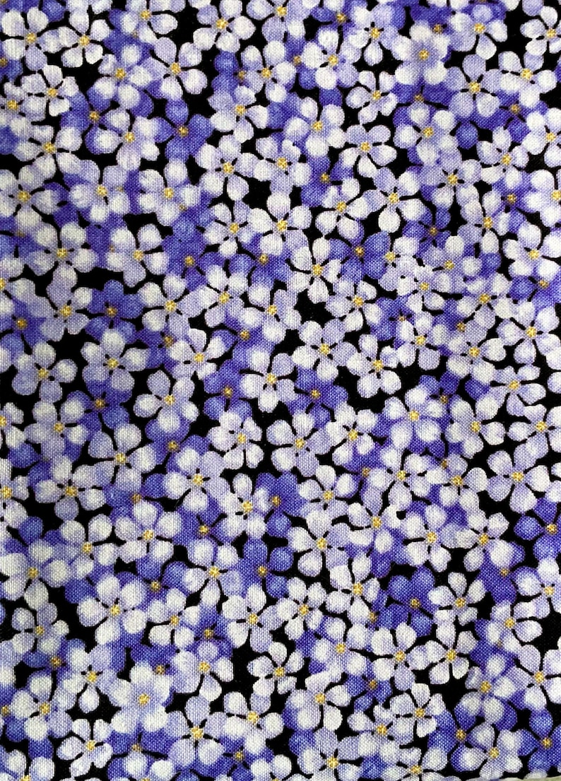 May include: A fabric pattern featuring a dense arrangement of small five-petalled flowers in shades of light purple, lavender, and white. Each flower has a tiny, bright yellow centre, and the blossoms are set against a solid black background.