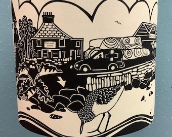 Lampshade featuring a design from an original paper cut showing Scottish Island life.