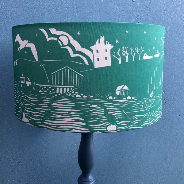 Lamp shade featuring a coastal design from an original paper cut