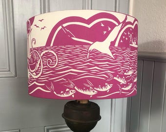 Lampshade with an original paper cut design of boats and sea creatures