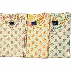May include: Three folded floral print nightgowns in cream, yellow, and blue. Each gown features a V-neck and a small tag that reads "JESSICA". The gowns have a floral pattern in shades of pink, orange, and green.