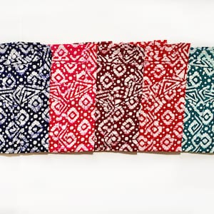 May include: Five fabric swatches with a white and blue geometric pattern. The swatches are in shades of blue, pink, burgundy, red, and teal.
