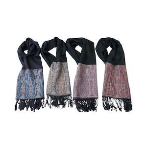 May include: Four black scarves with paisley patterned borders and fringe. The borders feature intricate designs in shades of blue, green, pink, and red. The scarves are displayed against a white background.
