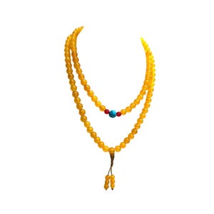 May include: A double-strand necklace composed of smooth, round yellow beads. The inner strand features a central turquoise blue bead flanked by two small red beads. The necklace terminates in a knotted cord with two small yellow bead dangles.