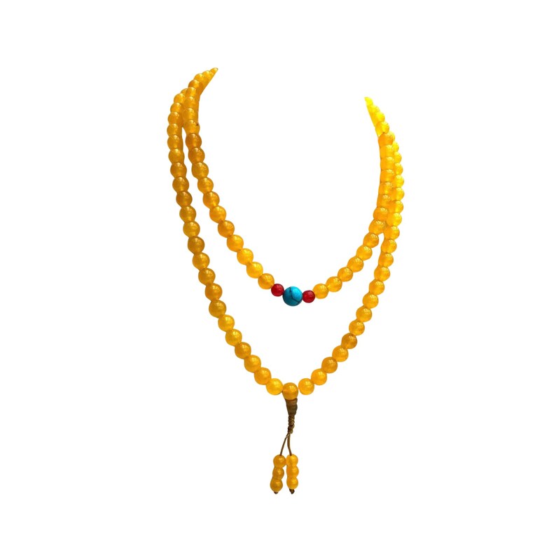 May include: A double-strand necklace composed of smooth, round yellow beads. The inner strand features a central turquoise blue bead flanked by two small red beads. The necklace terminates in a knotted cord with two small yellow bead dangles.
