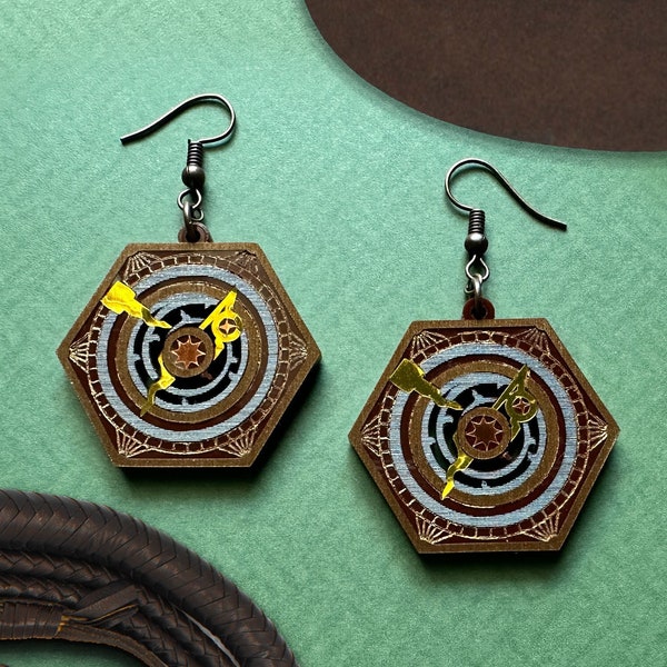 Inspired by the adventures of Indy, these "Dial of Destiny" earrings are fated to bring you timeless charm!