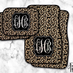 May include: Set of three leopard print car floor mats with black and white monogrammed initials "LHR" in the center of each mat.