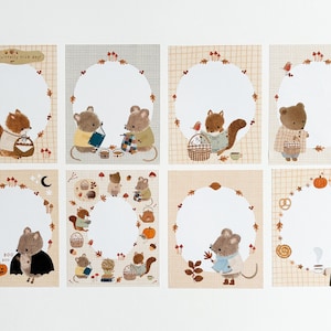 以下が含まれることがあります： リス、クマ、ネズミなどの森の動物が描かれたイラストカード8枚セット。各カードには、秋をテーマにした装飾で囲まれた、書き込み用の白い楕円形のスペースがあります。「Have a squirrelly nice day!」と書かれたカードが1枚あります。