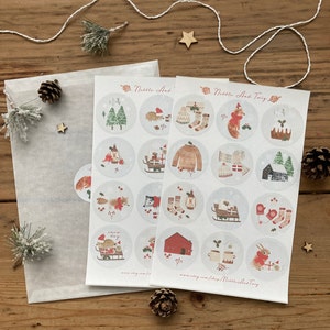 May include: Two sheets of stickers featuring illustrations of woodland animals and winter scenes. The stickers are round and have a white background with a light gray border. The text "Nibble And Twig" is printed on the top of the sheets.