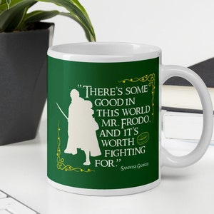May include: A green ceramic mug with a white silhouette of a person holding a sword. The mug has a white rim and handle. The text on the mug reads "There's some good in this world Mr. Frodo. And it's worth fighting for!" - Samwise Gamgee.