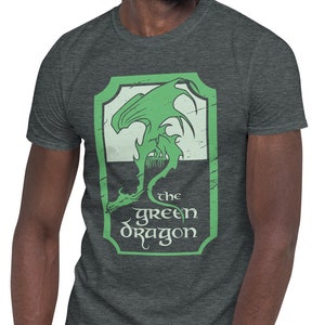May include: A heather grey t-shirt with a green dragon graphic and the text "the green dragon" in a vintage style.