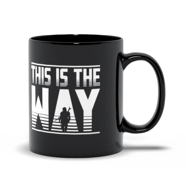 Puede incluir: Taza de caf&eacute; de cer&aacute;mica negra con un gr&aacute;fico blanco que dice "This is the Way" con una silueta de un personaje mandaloriano en el medio de la palabra "Way".