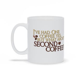 May include: White ceramic coffee mug with the text "I've had one coffee yes, but what about second coffee?" in brown and gold lettering with coffee bean illustrations.