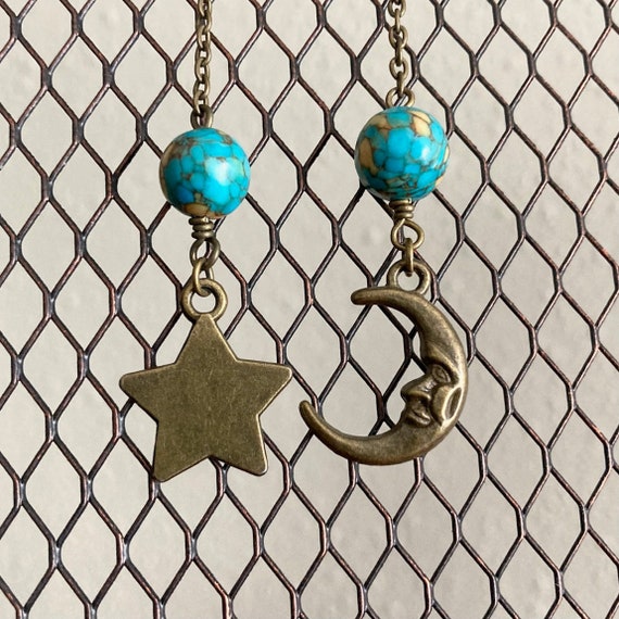 Long bronze tone moon and star earrings.