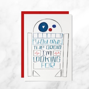 Könnte beinhalten: Eine weiße Karte mit rotem Rand zeigt eine handgezeichnete Illustration eines Roboters mit dem Text "You are the droid I'm looking for".