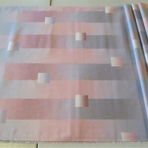 May include: A fabric with a striped pattern in shades of pink, gray, and white. The fabric has a subtle geometric design with squares.