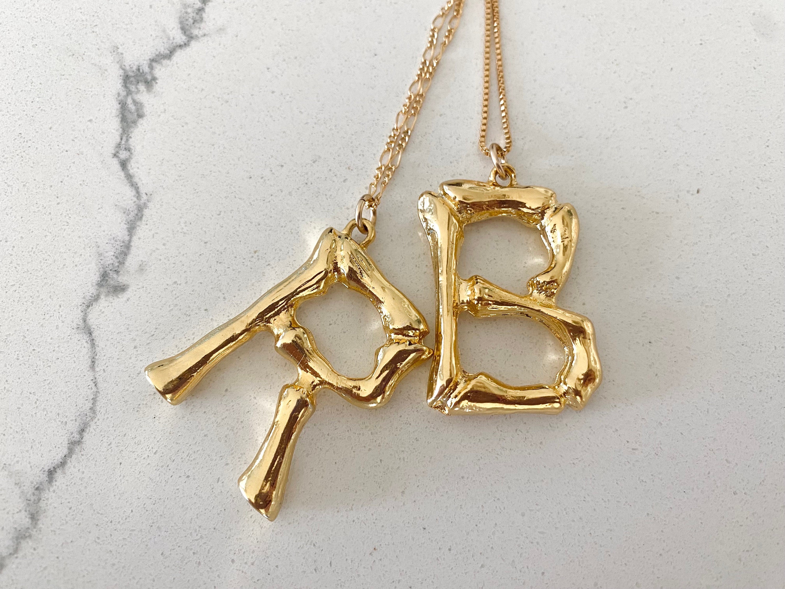 Celine Alphabet Pendant Necklace in Brass | Hypebae