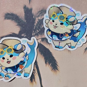 May include: Two stickers featuring a cartoon creature with a light tan body, blue accents, and a fish tail. The creature wears sunglasses and a life preserver. The stickers have a holographic effect and are surrounded by bubbles.