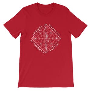 May include: Red t-shirt featuring a white graphic design of a skeleton within a geometric pattern. The text "GERARD THIBAULT MYSTERIOUS CIRCLE" encircles the skeleton.