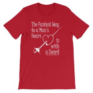 May include: Red t-shirt with white text that reads "The Fastest Way to a Man's Heart is with a Sword" and a white illustration of a sword piercing a heart.