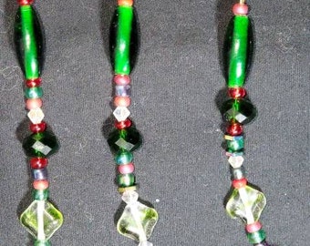Beaded Ornaments hand strung to catch the lights and sparkle you've decorated your tree and home with for the holidays.