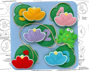 May include: A felt craft kit for kids featuring a frog, lily pads, and numbers. The kit includes a green frog, five lily pads with numbers 1-5, and yellow, pink, purple, and blue flowers. The lily pads are green with a white outline. The kit is designed for children to learn numbers and colors.