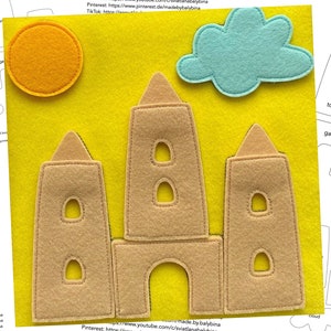 Könnte beinhalten: Ein Filz-Schloss-Spielset mit drei Türmen, einem Tor, einer Sonne und einer Wolke. Das Schloss ist braun, die Sonne ist gelb, die Wolke ist blau und das Tor ist weiß. Das Set befindet sich auf einem gelben Hintergrund.